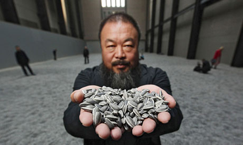 Chinese artist Ai Weiwei at his current exhibition of 100 million ceramic seeds at the Tate Modern 